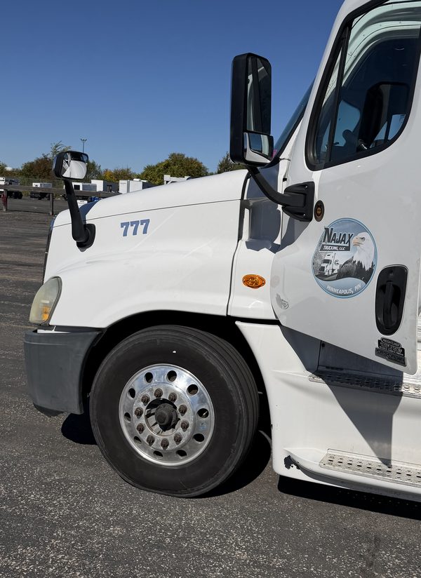 White Najax Trucking semi truck number 777 with the NAJAX TRUCKING LLC logo on the cab door